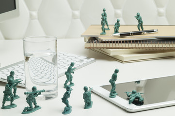 Miniature warriors are fighting on the office desk