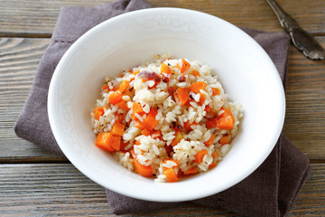 steamed rice with carrots in a white bowl