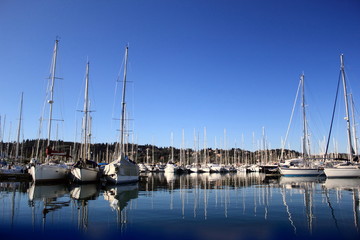 Yachts and boat reflections in harbor