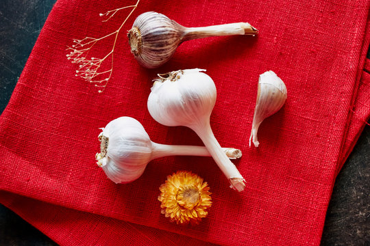 Three garlic on the red background