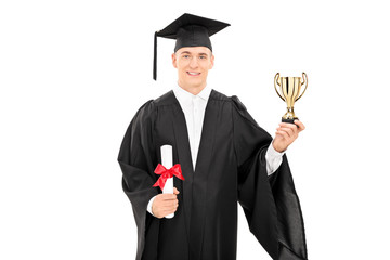 Male college graduate holding a golden trophy