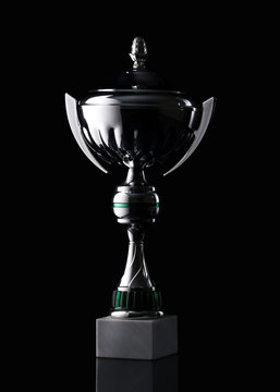 silver cup of the winner on black background