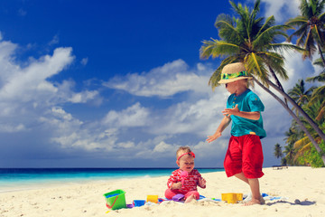 brother and sister playing on tropical beach