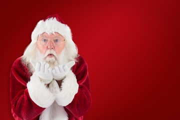 Composite image of santa claus blows something away