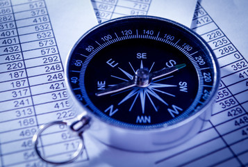 Compass Instrument on Top of Paper Reports