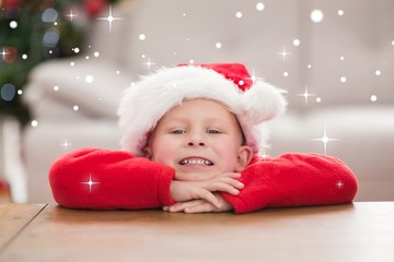 Obraz na płótnie Canvas Composite image of festive little boy smiling at camera