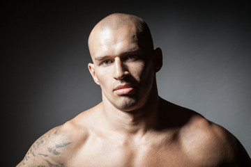 portrait of strong man isolated on dark background