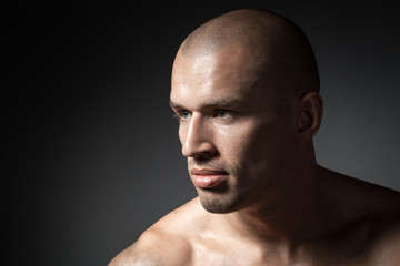 portrait of strong man isolated on dark background