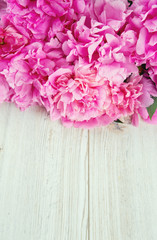 pink peonies on wooden surface