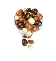 chocolate covered nuts and raisins isolated on white