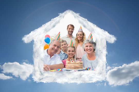 Composite image of cheeful family smiling at camera at birthday