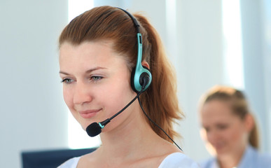Female customer support operator with headset and smiling