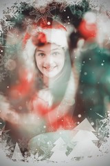 Composite image of festive litte girl decorating christmas tree
