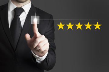 businessman pushing button five star rating