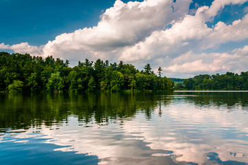 Clouds and trees reflecting in Lake Williams, in York, Pennsylva