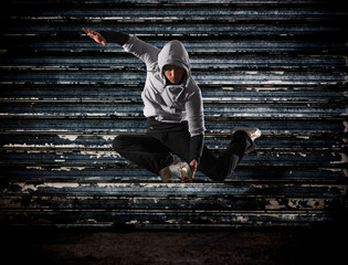 Modern hip-hop style teenage man jumping