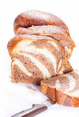 Slicing homemade fresh milk loaf on white background