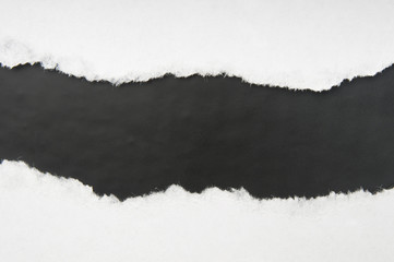 Torn white paper with black space