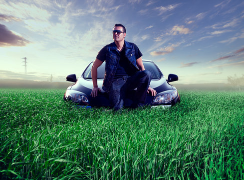Man and car concept.Green grass landscape