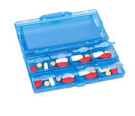 Prescription pills and vitamins in a blue pill box - days of wee