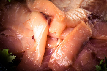 sliced salmon laid in a bowl with lemon. tinted