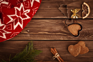 Gingerbread cookies and spices over wooden background 