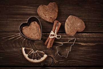 Gingerbread cookies and spices over wooden background 