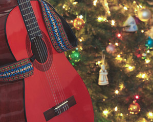 A Classical Guitar Beside a Christmas Tree