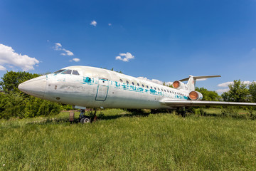 Fototapeta na wymiar Old russian aircraft Yak-42 at an abandoned aerodrome