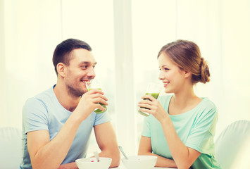 smiling couple having breakfast at home