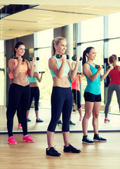 group of women with dumbbells in gym