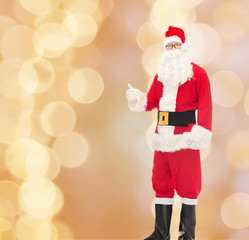 man in costume of santa claus showing thumbs up
