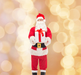 man in costume of santa claus with gift box