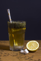 Still-life Of  A Glass Of Tea, Sugar Cubes And A Slice Of Lemon