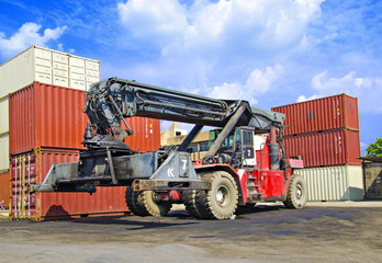 Obraz premium Stack of Freight Containers at the Docks with Truck