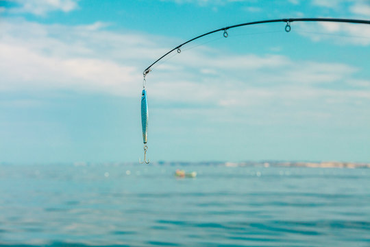 Saltwater Fishing - Rod With Wobbler And Blue Sea Water