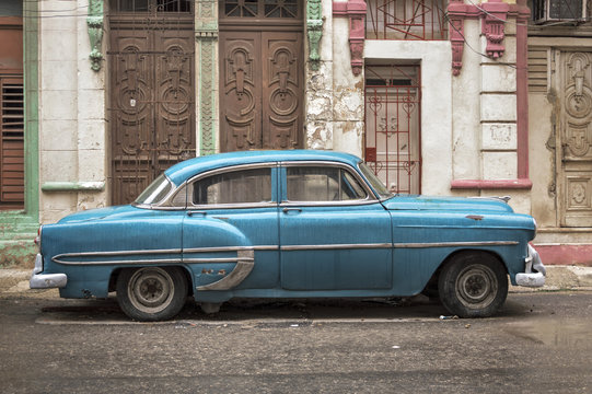 Blue car in Havana on a rainy day