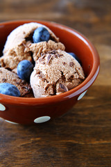Sweet ice cream with blueberries in deep bowl