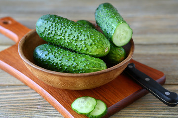 Cucumbers in a bowl on cutting board