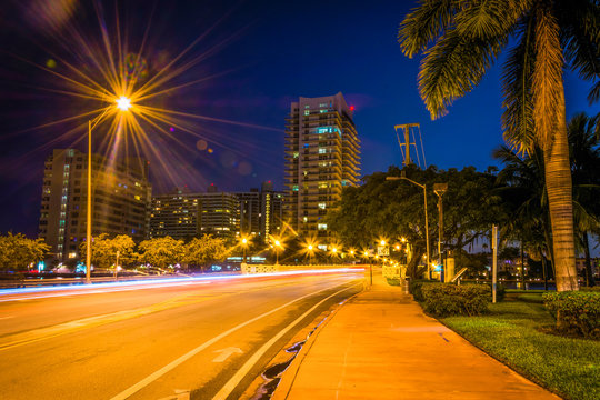 Palm trees and buildings along Dade Boulevard at night, in Miami