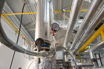 Place in a large industrial boiler room.