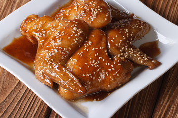 Chinese chicken wings glazed with sesame seeds close-up
