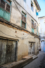 Naklejka premium Old dirty buildings in a street in an african city