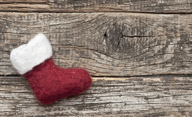 Obraz na płótnie Canvas Santa or christmas boot on a wooden background for a greeting ca