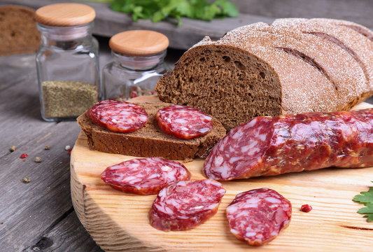 Sliced salami and bread on the kitchen table