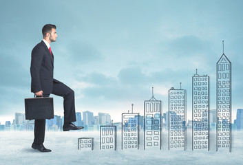 Business man climbing up on hand drawn buildings in city