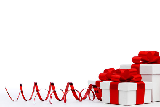 Gifts in white boxes with red ribbons