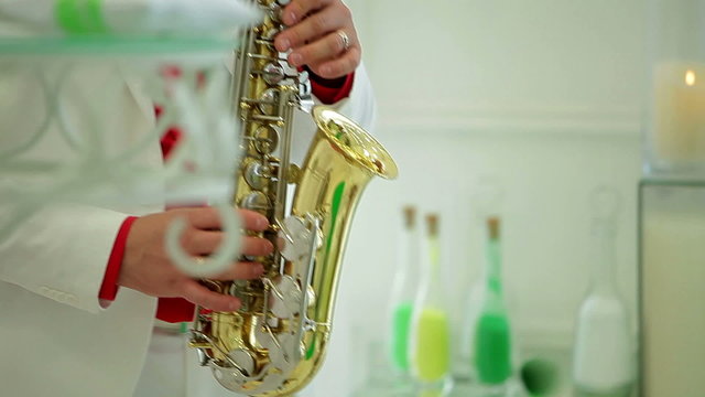 man in festive costume plays saxophone