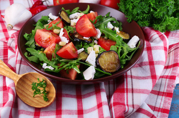 Eggplant salad with tomatoes, arugula and feta cheese,