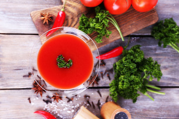 Tomato juice in goblet and fresh vegetables